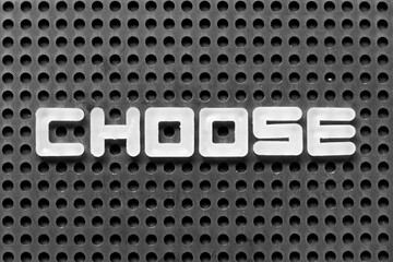 White alphabet letter in word choose on black pegboard background