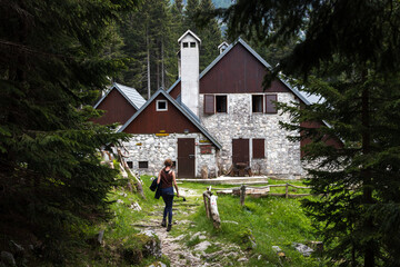 Female Hiker Reaching The Mountain Hut of Krn Lake in Triglav National Park Slovenia