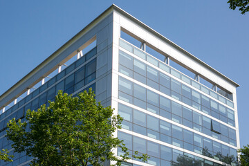 Facade of a glass building in the Eur district in Rome, Italy. There are many offices.