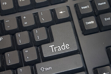 Black Computer Keyboard with Trade text. Close-up of an electronic Computer Device part, keypad.