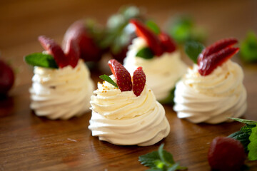 Small cupcake of Pavlova desert, light egg and sugar desert with cream and strawberries