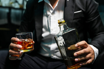 Closeup businessmen holding a glass of whiskey