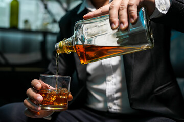 Closeup businessmen holding a glass of whiskey