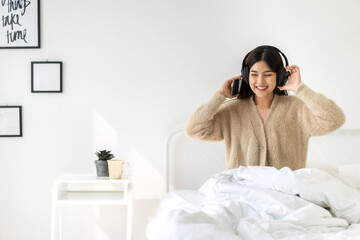 Portrait of smiling cheerful beautiful pretty asian woman clean fresh healthy white skin posing smile in pajamas clothes.Girl felling relax and enjoy time on the bed at home.asia beauty