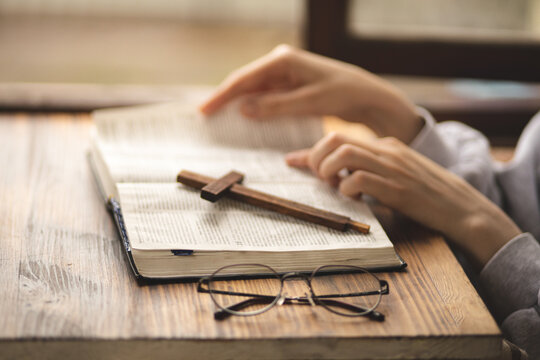 Close-up Of Hands On The Bible. The Process Of Studying The Bible. Prayer And Worship Of God. Study Of The Holy Scriptures. Studying In Theological Seminary. Theology.