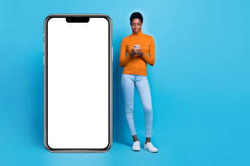 Full length photo of focused trans bisexual male surfing social network near blank copy empty space isolated on blue color background