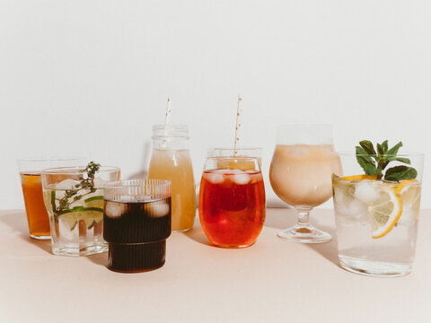 Various refreshing non-alcoholic drinks in glasses with ice