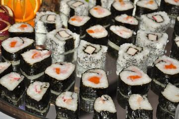 froid buffet table with canapes and savory snacks with meats fruits cheeses with decorations of carved vegetables in event hall