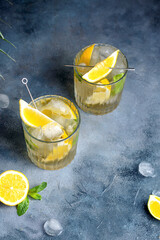 citrus lemonade with mint and lemon in the glass with ice cubes.