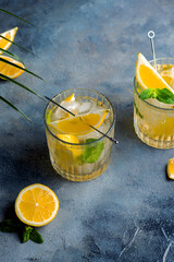 citrus lemonade with mint and lemon in the glass with ice cubes.