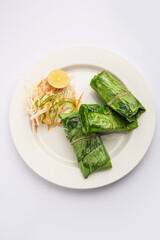 patrani paneer, a paneer marinated in sauce and barbecued and then covered in leaf