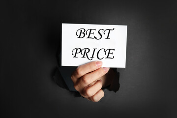 Woman holding card with phrase Best Price hole in black paper, closeup