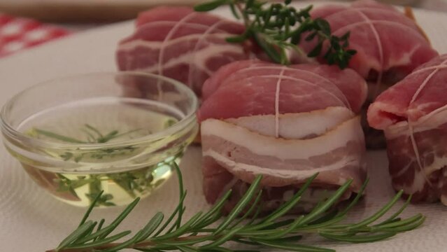 paupiettes de porc cru &agrave; l'huile et aux romarin dans une assiette 