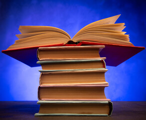 Wisdom and education concept.Book on the table, love reading. Retro neon light 90s