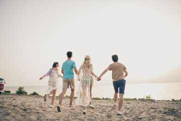 Photo of dream youth fellows enjoy weekend seacoast horizon sunset wear boho outfit nature seaside beach outside