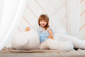 Obraz na płótnie Canvas Cute little girl with a huge soft toy