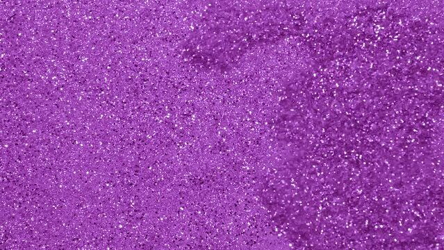 Purple Sparkle and glowing particles wave and light abstract background. Shining glitter particles slow motion background.