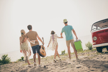 Photo of best buddies walk hold hands enjoy summer love life wear casual outfit nature seaside beach outdoors