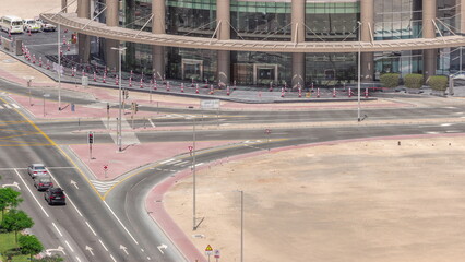 Fototapeta premium Bussy traffic on the road intersection in Dubai business bay district aerial timelapse, UAE