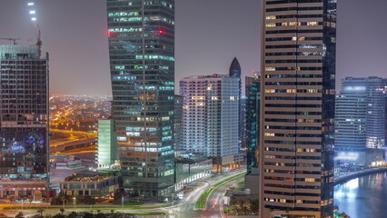 Fototapeta na wymiar Cityscape of skyscrapers in Dubai Business Bay with water canal aerial night timelapse