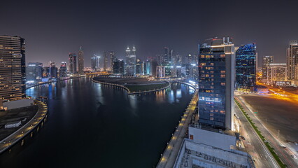 Obraz premium Panorama showing cityscape of skyscrapers in Dubai Business Bay with water canal aerial night timelapse