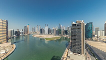 Naklejka premium Cityscape skyscrapers of Dubai Business Bay with water canal aerial timelapse.