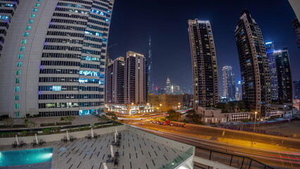 Aerial panorama of Dubai downtown and difc skyscrapers night timelapse.