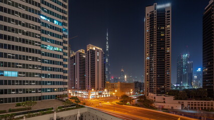 Obraz na płótnie Canvas Aerial panoramic view to Dubai downtown and difc skyscrapers all night timelapse.