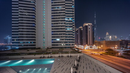 Fototapeta na wymiar Aerial panoramic view to Dubai downtown and difc skyscrapers night timelapse.