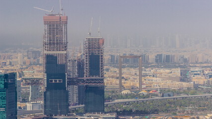 Aerial view of skyscrapers under construction in Dubai timelapse.