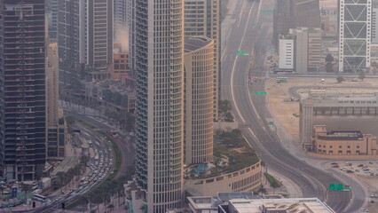 Bussy traffic on a road intersection in Dubai downtown aerial timelapse.