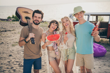 Photo of carefree positive 60s style people enjoy music fest wear boho outfit nature seaside beach...