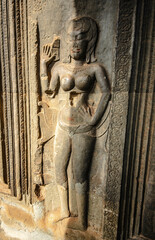 A sandstone wall carving depicting an Apsara with bob-like hair in Angkor Wat Siem Reap, Cambodia.