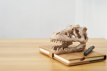 concept of Paleontology education background. dinosaur skull on wooden table clean mood background ...