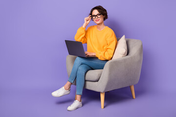 Full length portrait of pretty satisfied lady sit chair use wireless netbook write email isolated...
