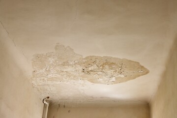 Water damage on white ceiling in an old house