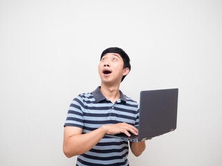 Man striped shirt holding laptop excited looking up copy space