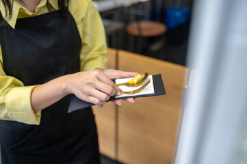 Womans hands holding cutlery in napkin