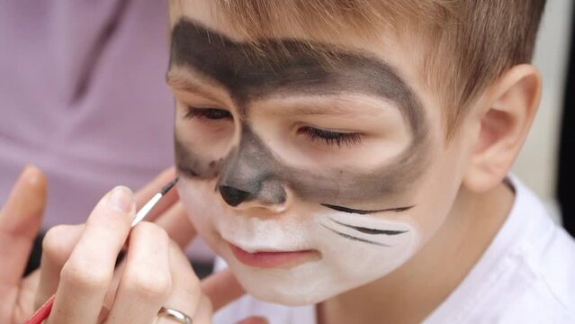 The boy is painted on the face