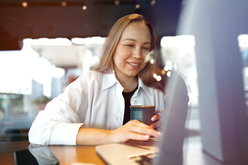 Portrait of young business woman drinking coffee in cafe