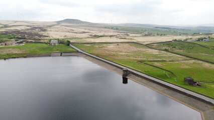 Aerial view of a lake surrounded by rural farmland and green countryside. 
