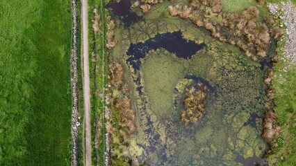 Aerial view looking down onto green countryside and farmland. Taken in Lancashire England. 