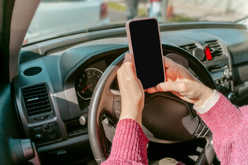 Person with the cellphone seated in the automobile