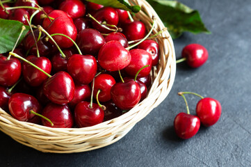 Fresh ripe organic red cherries in a basket, heap of summer fruits concept