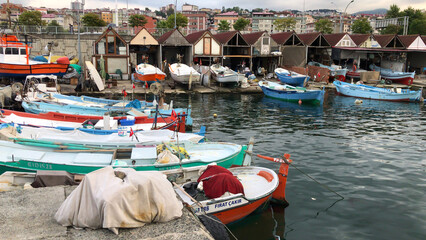 Fototapeta na wymiar Trabzon, Turkey - August 28 2020: Fishing Boats, Fish Nets. Faroz fisher shelters (AKA Trabzon Balıkçı Barınakları). 