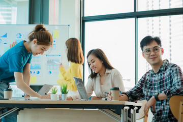 Young business finance teams in Asia work together in project brainstorming sessions. plan a strategy small start up company or office collaboration ideas