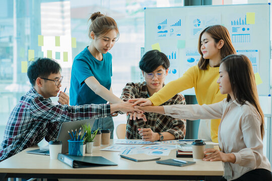 Young business finance teams in Asia work together and stand together to brainstorm projects. Strategic Small Startup or Office Collaboration Ideas Business Teamwork Ideas: