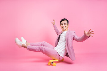 Image of young Asian man playing skateboard on background © Timeimage
