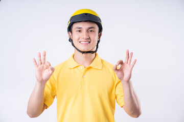 Image of young Asian delivery man on background