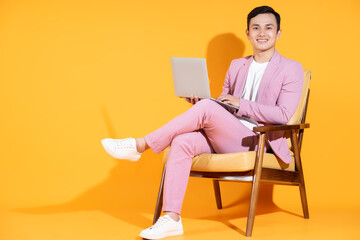 Image of young Asian man sitting on chair